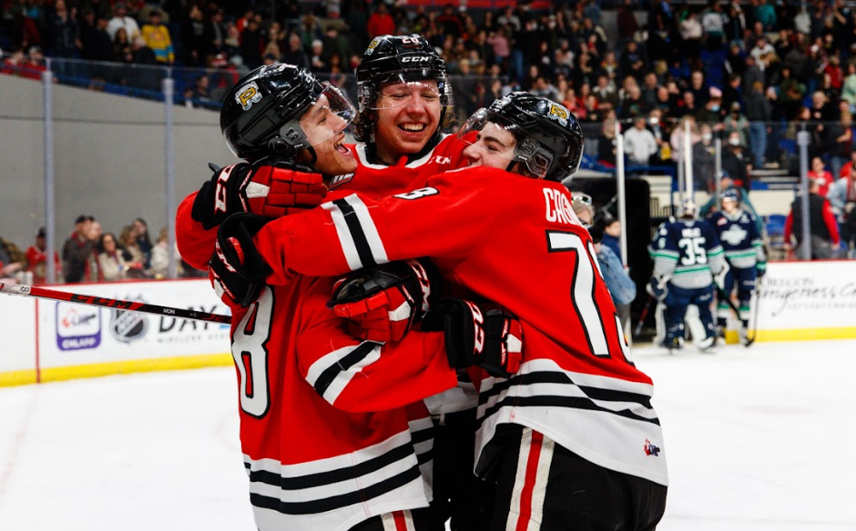 Josh Mori, Marek Alscher, and Luca Cagnoni of the Portland Winterhawks share a hug