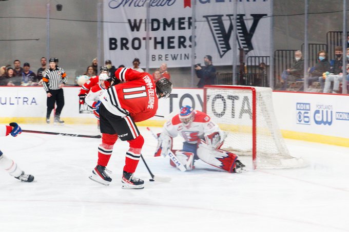 Robbie Fromm-Delorme of the Portland Winterhawks takes a shot on net during a game against the Spokane Chiefs