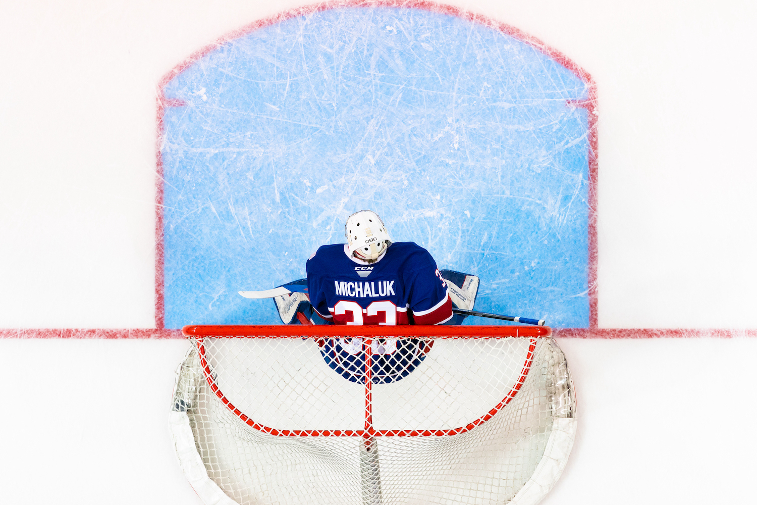 Spokane Chiefs goaltender Cooper Michaluk in net as seen from an overhead view.