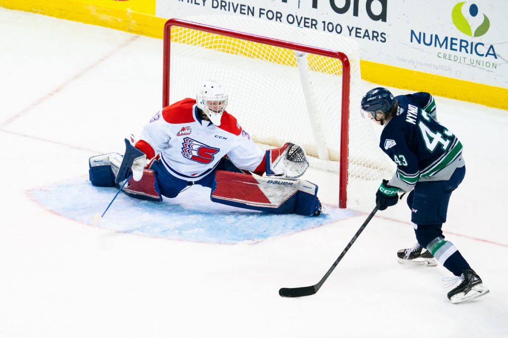 Spokane Chiefs goaltender Cooper Michaluk prepares to for a shot from Seattle Thunderbirds player Sawyer Mynio.