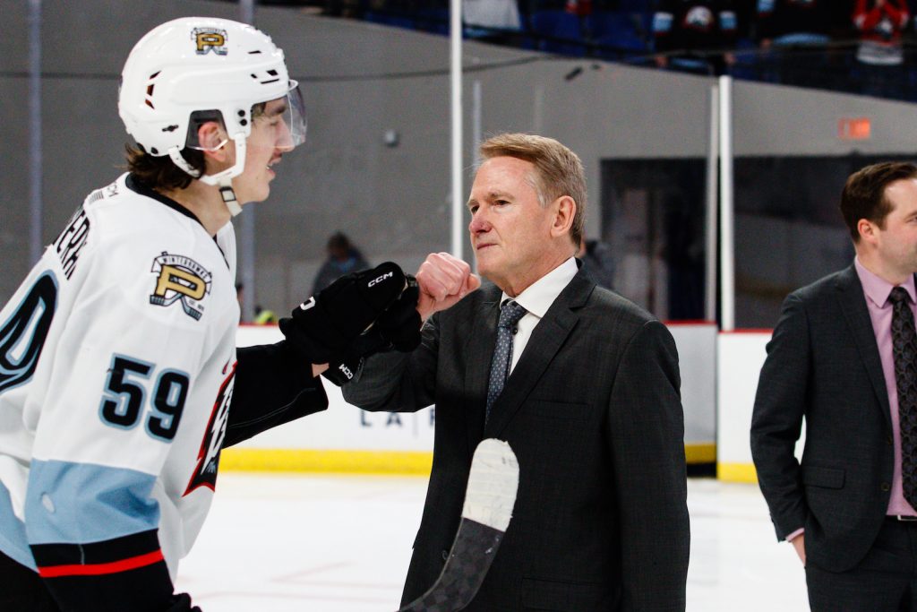 Carter Sotheran fistbumps Portland Winterhawks head coach Mike Johnston