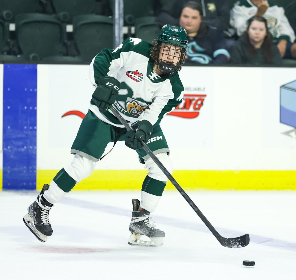 Ethan Makokis on the ice in hockey gear.