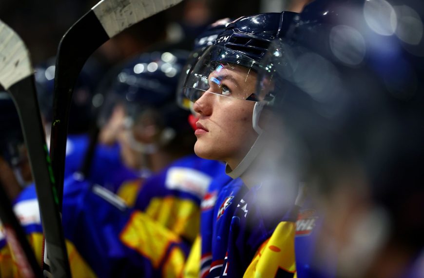 A side profile shot of Jaxsin Vaughan sitting on the bench.